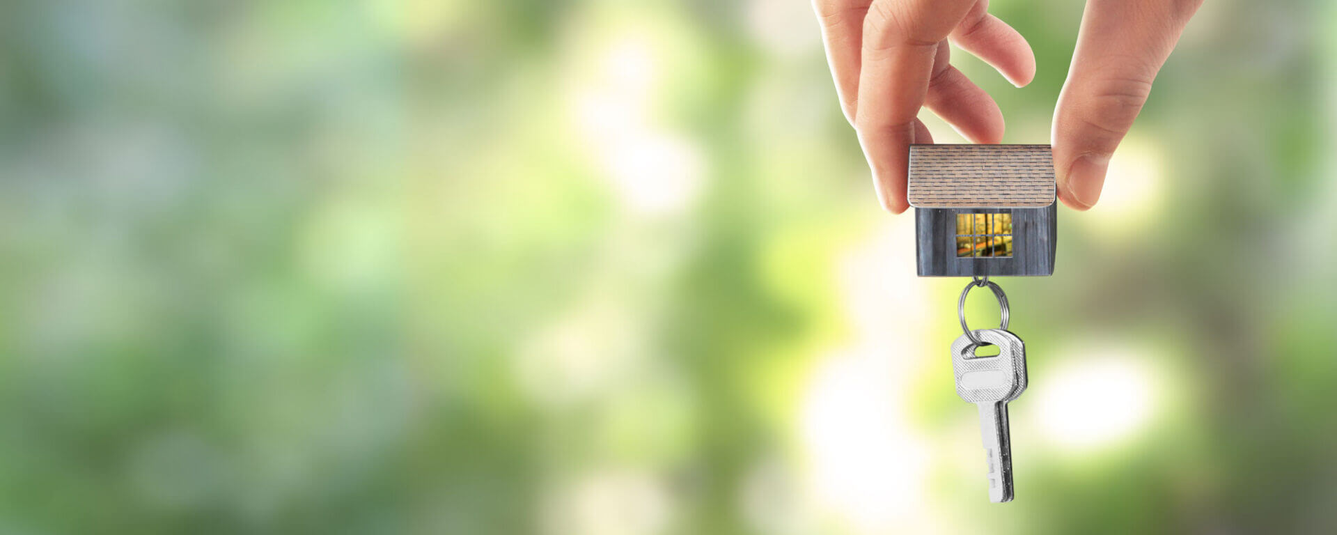 Real Estate Agent Handing Over House Keys In Hand